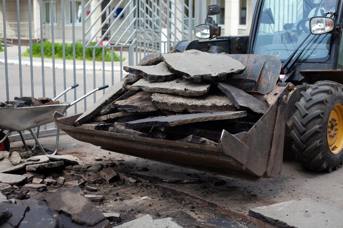 Workers installing new curbs during a road repair on the highway