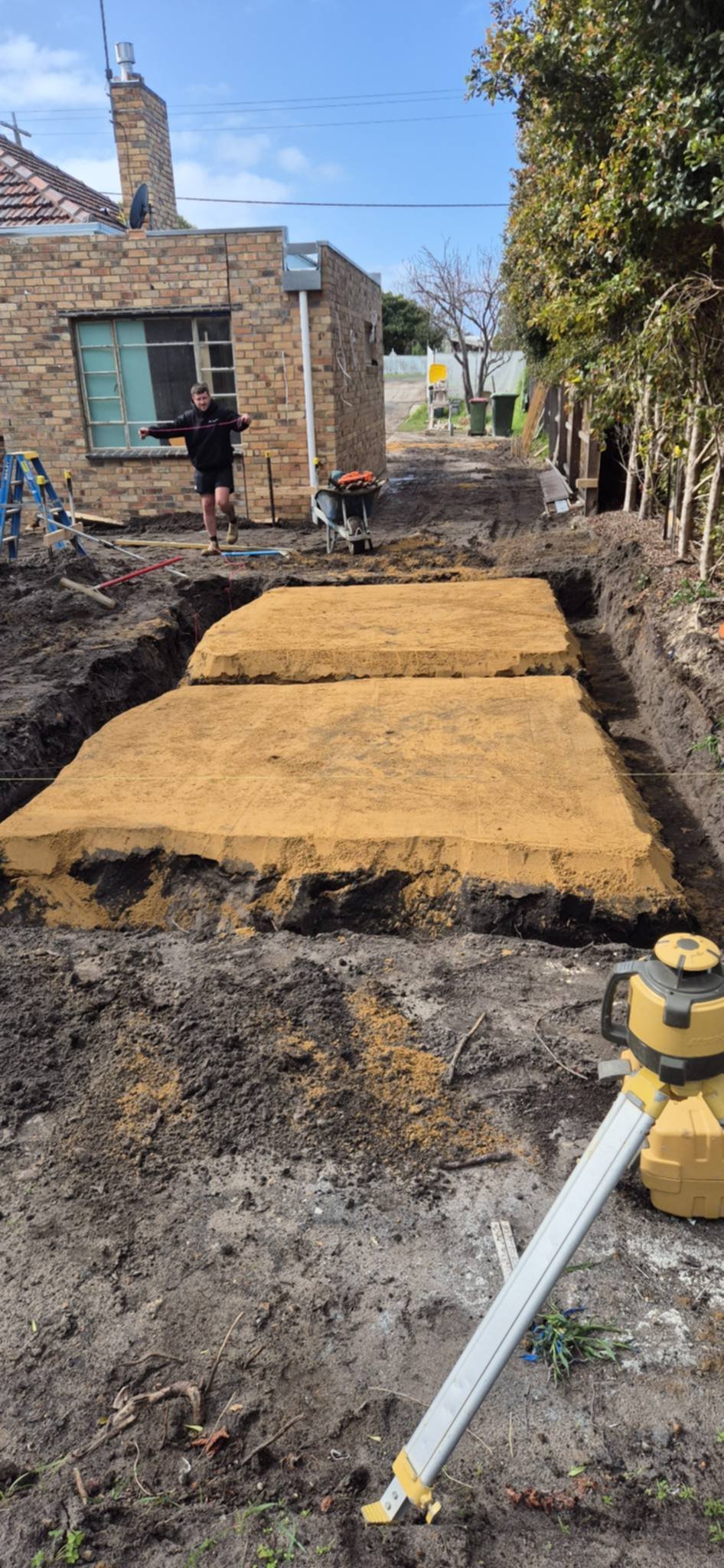 Concrete foundation slabs laid out in an excavated trench during home construction